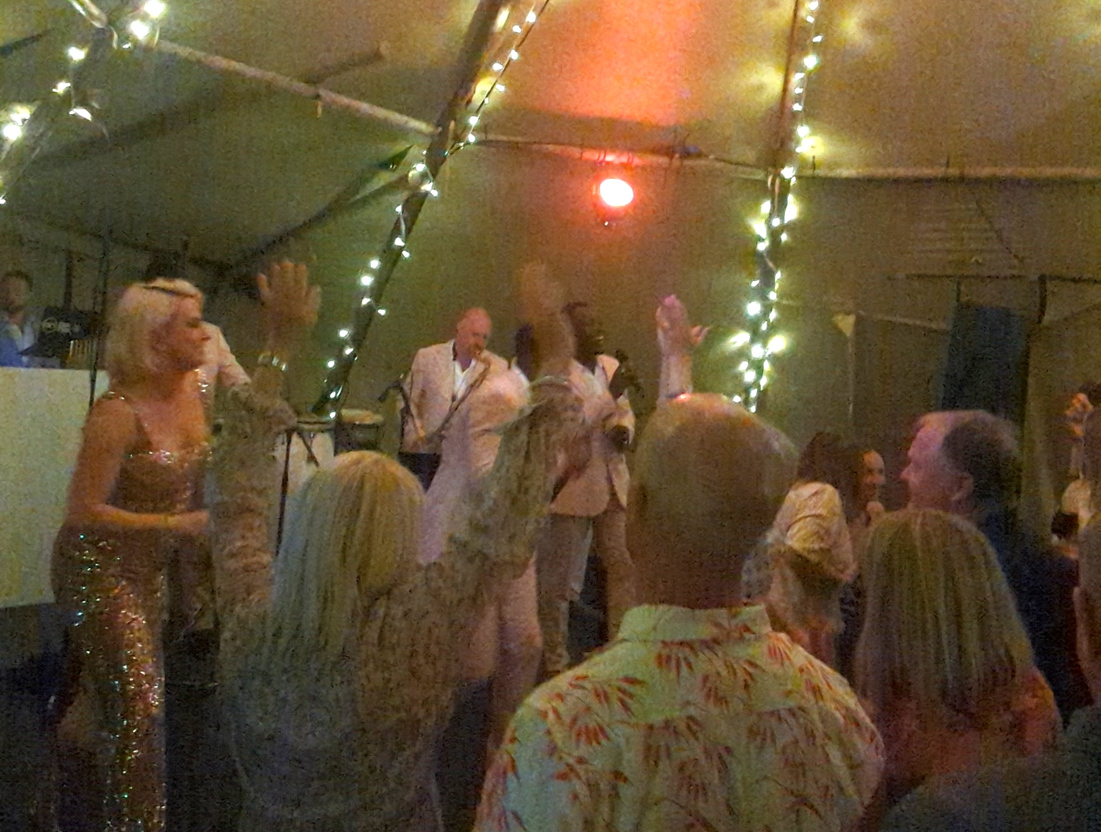 Guests dancing to Sensation Band in a fairy-lit tipi