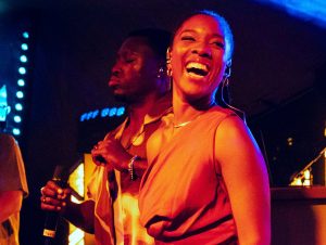 MYERA singer laughing on stage at a 40th birthday party